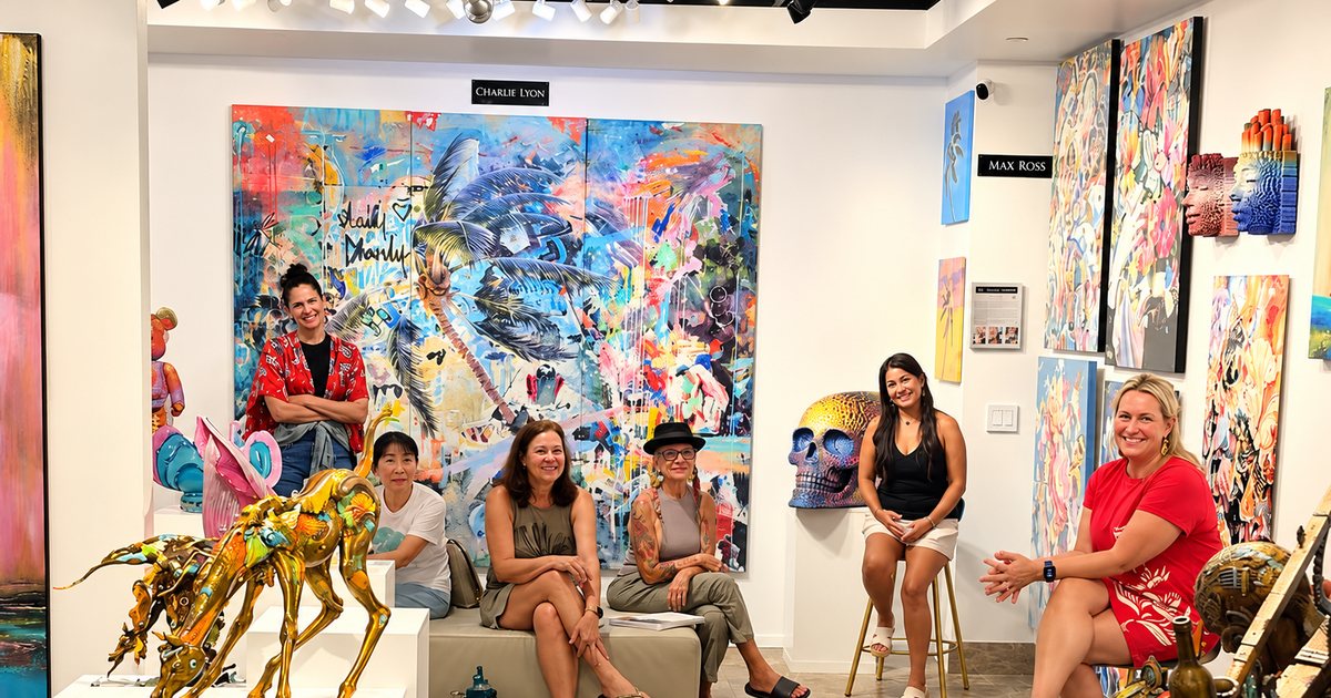 Dr. G and guests smiling together among colorful paintings at Enchantress & Freeborne Gallery during Menopause & Mimosas, Wailea, Maui